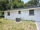 Exterior of home with an AC unit, highlighting the house's functional aspects and design at 6317 Buster Dr, Tampa, FL 33619