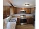 Modern kitchen with stainless steel appliances, gorgeous cabinets, and a sink overlooking the yard at 6317 Buster Dr, Tampa, FL 33619