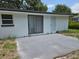 Outdoor patio area featuring a sliding glass door and a door, perfect for entertaining or relaxing at 6317 Buster Dr, Tampa, FL 33619