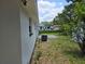 Side yard showcasing the home's exterior and landscaping, with an AC unit visible at 6317 Buster Dr, Tampa, FL 33619