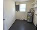 A utility room featuring a water heater, electrical panel, and shelving for convenient storage at 6317 Buster Dr, Tampa, FL 33619