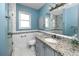 Well-appointed bathroom with a vanity, granite countertop, tiled shower, and ample natural light at 6536 115Th Ln, Seminole, FL 33772