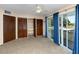 Bright bedroom featuring plush carpeting, closet space, and sliding glass door to the outside at 6536 115Th Ln, Seminole, FL 33772
