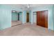 Spacious bedroom with light-blue walls, carpet, ceiling fan, and access to large closet at 6536 115Th Ln, Seminole, FL 33772