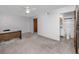 Bedroom featuring carpet, ceiling fan, and view to bathroom. Includes desk and chair at 6536 115Th Ln, Seminole, FL 33772