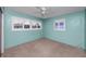 Well-lit bedroom features carpeted floors, blue walls, a ceiling fan, and shuttered windows at 6536 115Th Ln, Seminole, FL 33772