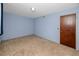 Serene blue bedroom featuring plush carpeting, a closet, and a neutral door at 6536 115Th Ln, Seminole, FL 33772