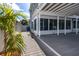 Exterior view showcasing the covered patio area and connection to the sunroom, perfect for outdoor living at 6536 115Th Ln, Seminole, FL 33772