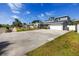 Expansive driveway leading to a well-maintained two-story home with manicured lawn and landscaping at 6536 115Th Ln, Seminole, FL 33772