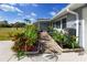 Paver walkway lined with colorful plants leading to the entrance of this beautifully landscaped home at 6536 115Th Ln, Seminole, FL 33772