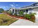 Inviting home exterior with lush landscaping, vibrant flowers and decorative details at 6536 115Th Ln, Seminole, FL 33772