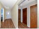 Hallway with wood-look floors, neutral walls, access to the front door and two closets at 6536 115Th Ln, Seminole, FL 33772