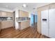 Open kitchen with white appliances, modern cabinetry, and views into the bright blue living room at 6536 115Th Ln, Seminole, FL 33772