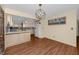 Open kitchen and dining area with updated light wood cabinets, modern lighting, and stainless appliances at 6536 115Th Ln, Seminole, FL 33772