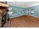 Bright living room featuring hardwood floors, a brick fireplace, and French doors at 6536 115Th Ln, Seminole, FL 33772