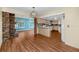 Open-concept living space with hardwood floors, fireplace, and views into the kitchen area at 6536 115Th Ln, Seminole, FL 33772