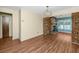 Open living area with a brick fireplace, modern lighting, and hardwood flooring at 6536 115Th Ln, Seminole, FL 33772