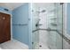 Modern bathroom showcasing a glass-enclosed shower with white marble-style tile and upscale fixtures at 6536 115Th Ln, Seminole, FL 33772