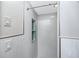 Modern bathroom featuring white tile shower, rainfall shower head and sleek inset shelving for storage at 6536 115Th Ln, Seminole, FL 33772