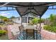 Backyard patio with checkered pavers, a gazebo with seating, and lush landscaping at 6801 Pinellas Point S Dr, St Petersburg, FL 33712