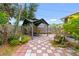 Backyard patio with checkered pavers and a gazebo with outdoor seating, and plants at 6801 Pinellas Point S Dr, St Petersburg, FL 33712