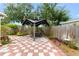 Backyard patio with checkered pavers and a gazebo with outdoor seating at 6801 Pinellas Point S Dr, St Petersburg, FL 33712