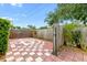 Cozy backyard featuring a checkered tile patio area, perfect for outdoor lounging and entertaining at 6801 Pinellas Point S Dr, St Petersburg, FL 33712