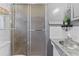 Compact bathroom with modern vanity, silver fixtures, and glass-enclosed shower at 6801 Pinellas Point S Dr, St Petersburg, FL 33712