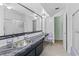 Bathroom with stainless steel sink, marble counter, shower and decorative chair at 6801 Pinellas Point S Dr, St Petersburg, FL 33712