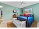 Cozy bedroom with a ceiling fan, wood furniture, and bright-colored bedding at 6801 Pinellas Point S Dr, St Petersburg, FL 33712