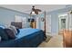 Comfortable bedroom featuring wood furnishings, a ceiling fan, and a large window at 6801 Pinellas Point S Dr, St Petersburg, FL 33712