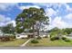 Charming home featuring well-maintained landscaping and a welcoming facade with mature shade trees in a serene neighborhood at 6801 Pinellas Point S Dr, St Petersburg, FL 33712