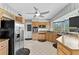 Bright kitchen boasts stainless steel appliances, granite counters, and a modern ceiling fan for comfortable cooking at 6801 Pinellas Point S Dr, St Petersburg, FL 33712