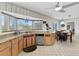 Eat-in kitchen with stainless steel dishwasher, granite countertops, and a bay window overlooking the yard at 6801 Pinellas Point S Dr, St Petersburg, FL 33712