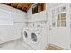 Functional laundry room with washer, dryer, utility sink, and convenient access to the exterior at 6801 Pinellas Point S Dr, St Petersburg, FL 33712