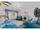 Comfortable living room featuring plush seating, a decorative fireplace, and soft natural light at 6801 Pinellas Point S Dr, St Petersburg, FL 33712