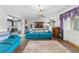 Bright living room with a blue sofa, and seamless flow to the rest of the home's living spaces at 6801 Pinellas Point S Dr, St Petersburg, FL 33712