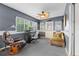 Bright sun room featuring comfortable furniture, a well-equipped workspace, and lots of natural light at 6801 Pinellas Point S Dr, St Petersburg, FL 33712