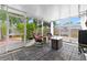 Relaxing sunroom features tiled floor and views of the lush backyard at 6801 Pinellas Point S Dr, St Petersburg, FL 33712