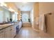 Bright bathroom with a double vanity, soaking tub, and linen closet at 6933 Cozumel Ct, Land O Lakes, FL 34637