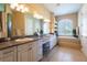 Spacious bathroom with a double vanity, makeup table and relaxing soaking tub at 6933 Cozumel Ct, Land O Lakes, FL 34637