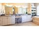 Bright bathroom features dual sinks with granite countertop and white cabinetry plus separate makeup vanity at 6933 Cozumel Ct, Land O Lakes, FL 34637