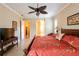 Inviting main bedroom features a ceiling fan, neutral paint, and access to the en-suite bathroom at 6933 Cozumel Ct, Land O Lakes, FL 34637