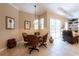 Warm dining area featuring a glass table, rattan chairs, and bright natural light from large sliding glass doors at 6933 Cozumel Ct, Land O Lakes, FL 34637