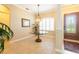 Elegant foyer showcasing a decorative light fixture, round glass table, and tiled flooring at 6933 Cozumel Ct, Land O Lakes, FL 34637
