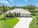 Charming single-story home boasting a well-manicured lawn, tile roof, and a spacious three-car garage at 6933 Cozumel Ct, Land O Lakes, FL 34637