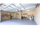 Well-lit garage offering ample space, with room for 2 cars and storage, featuring epoxy-coated floors and clean walls at 6933 Cozumel Ct, Land O Lakes, FL 34637
