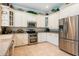 Modern kitchen featuring stainless steel appliances, granite countertops, and sleek white cabinetry at 6933 Cozumel Ct, Land O Lakes, FL 34637