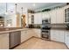 Well-equipped kitchen with stainless steel appliances, granite countertops, and white cabinetry at 6933 Cozumel Ct, Land O Lakes, FL 34637
