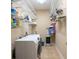 Convenient laundry room with washer, dryer and ample shelving for storage at 6933 Cozumel Ct, Land O Lakes, FL 34637